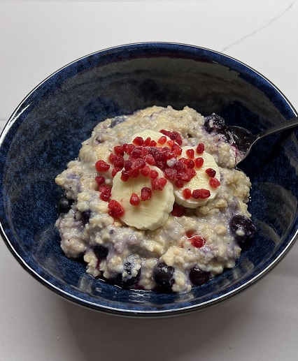 protein oats in bowl with berries and spoon